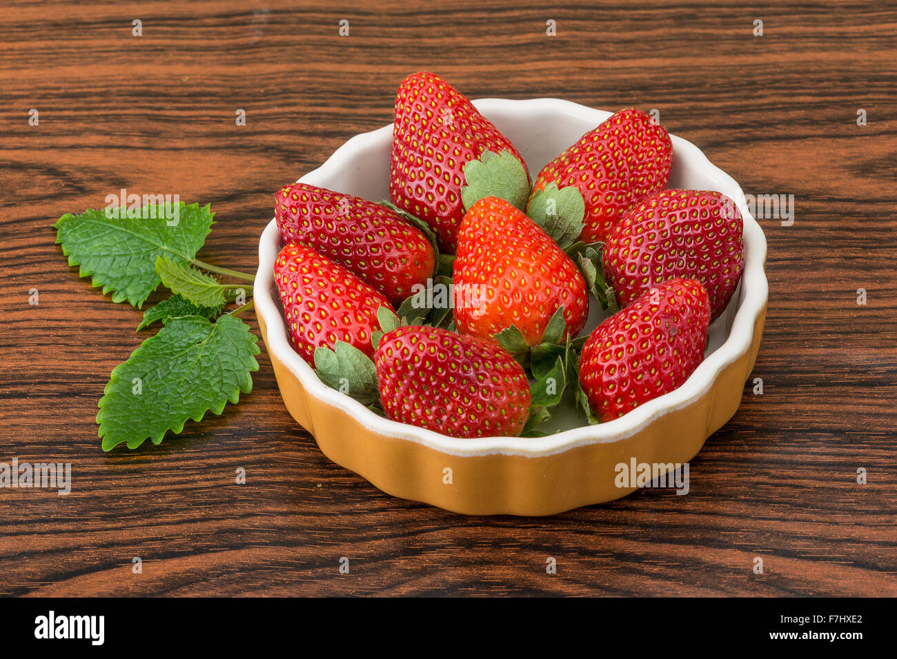Fresh ripe strawberries in the bowl on wooden background Stock Photo ...