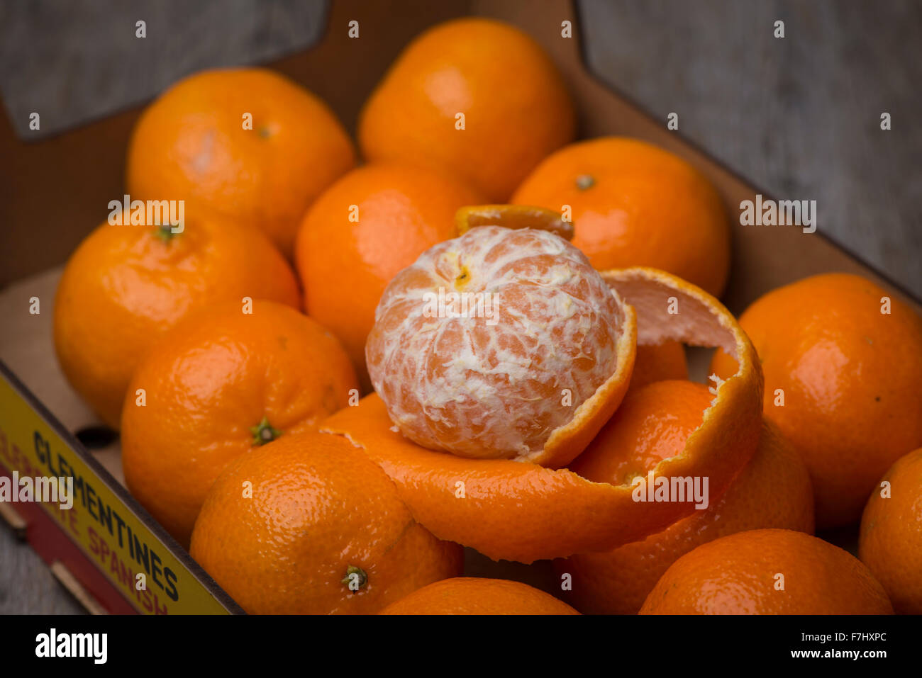 box of clementines with peeled clementine Stock Photo Alamy