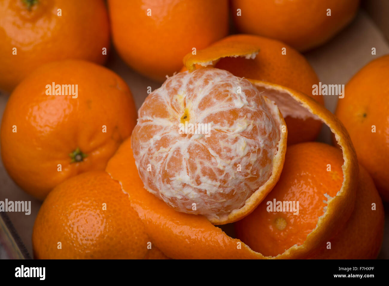 box of clementines with peeled clementine Stock Photo Alamy