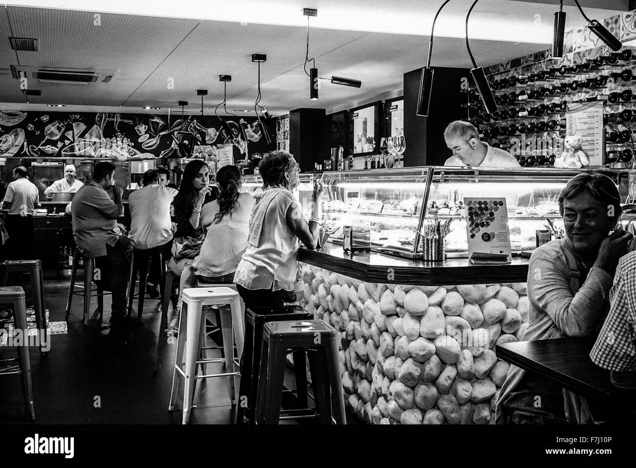 Tapas bar in busy Benidorm, old town, Spain. Black and white image, monochrome high contrast grainy. Stock Photo