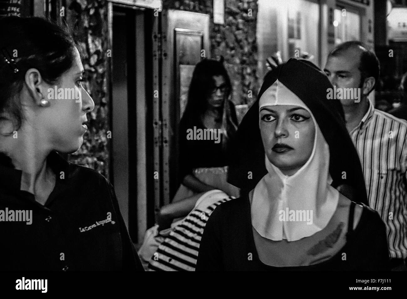 Woman dressed as nun with heavy makeup in Spanish town. Black and white monochrome image in the street Stock Photo