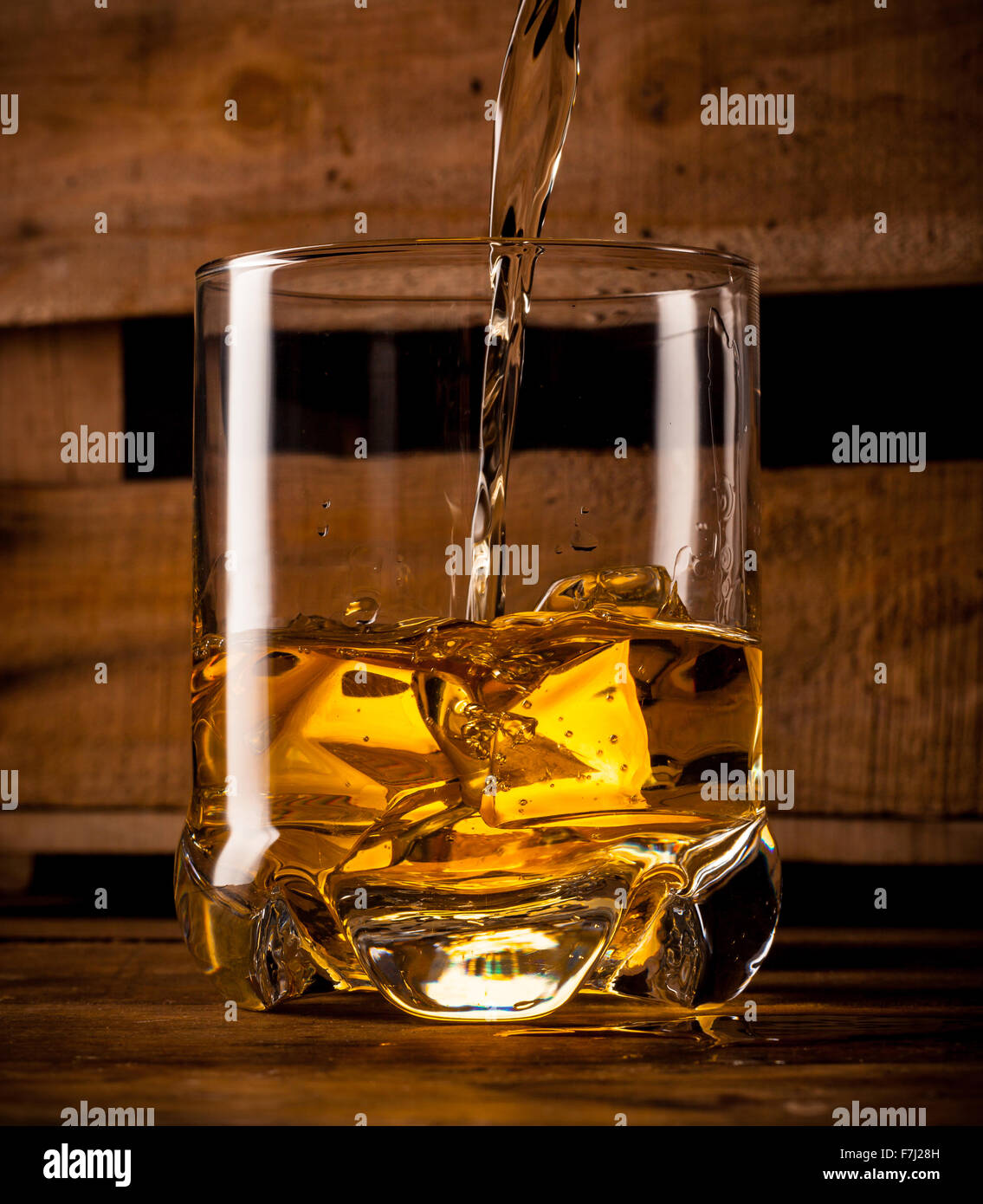 Pouring whisky in a glass Stock Photo