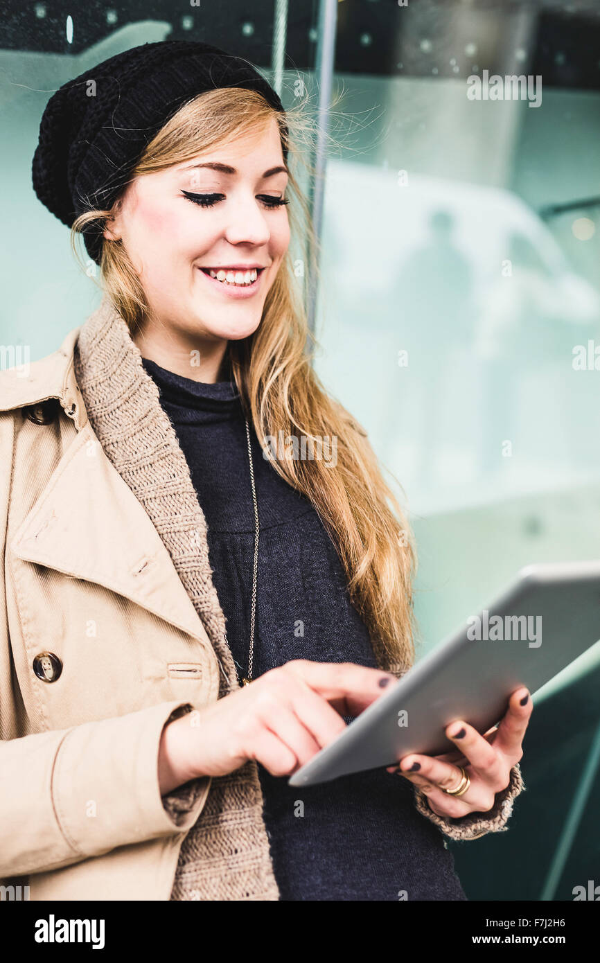 Blonde woman using a digital tablet Stock Photo