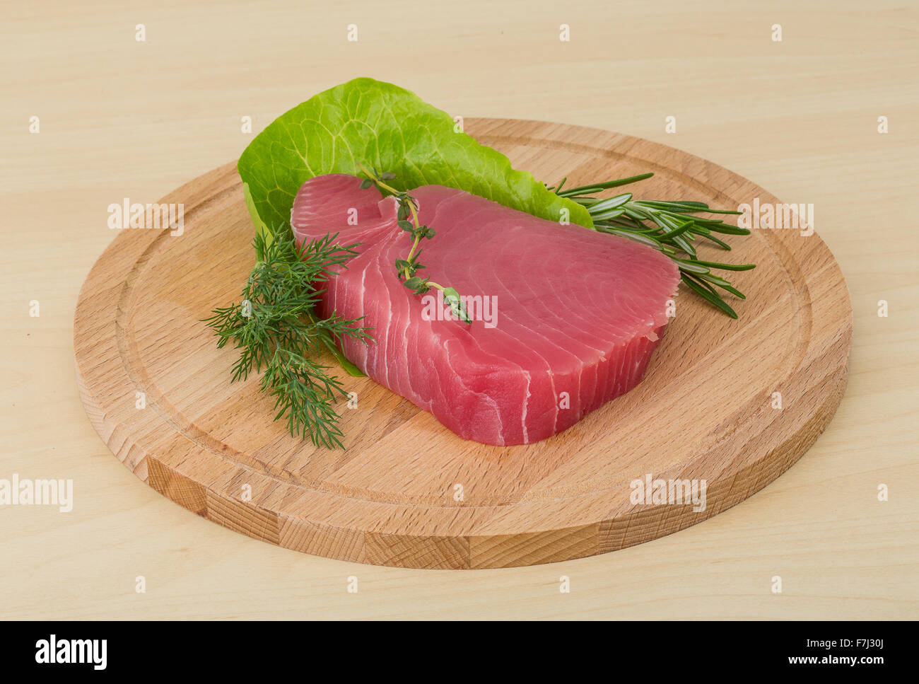 Raw tuna steak with rosemary and thyme Stock Photo Alamy