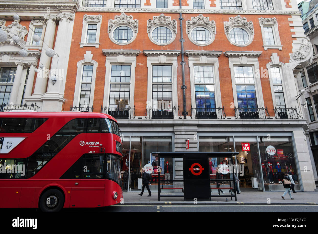 A double decker bus stopping at a bus stop outside Uniqlo clothes shop in  Oxford Street, London, England, UK Stock Photo - Alamy