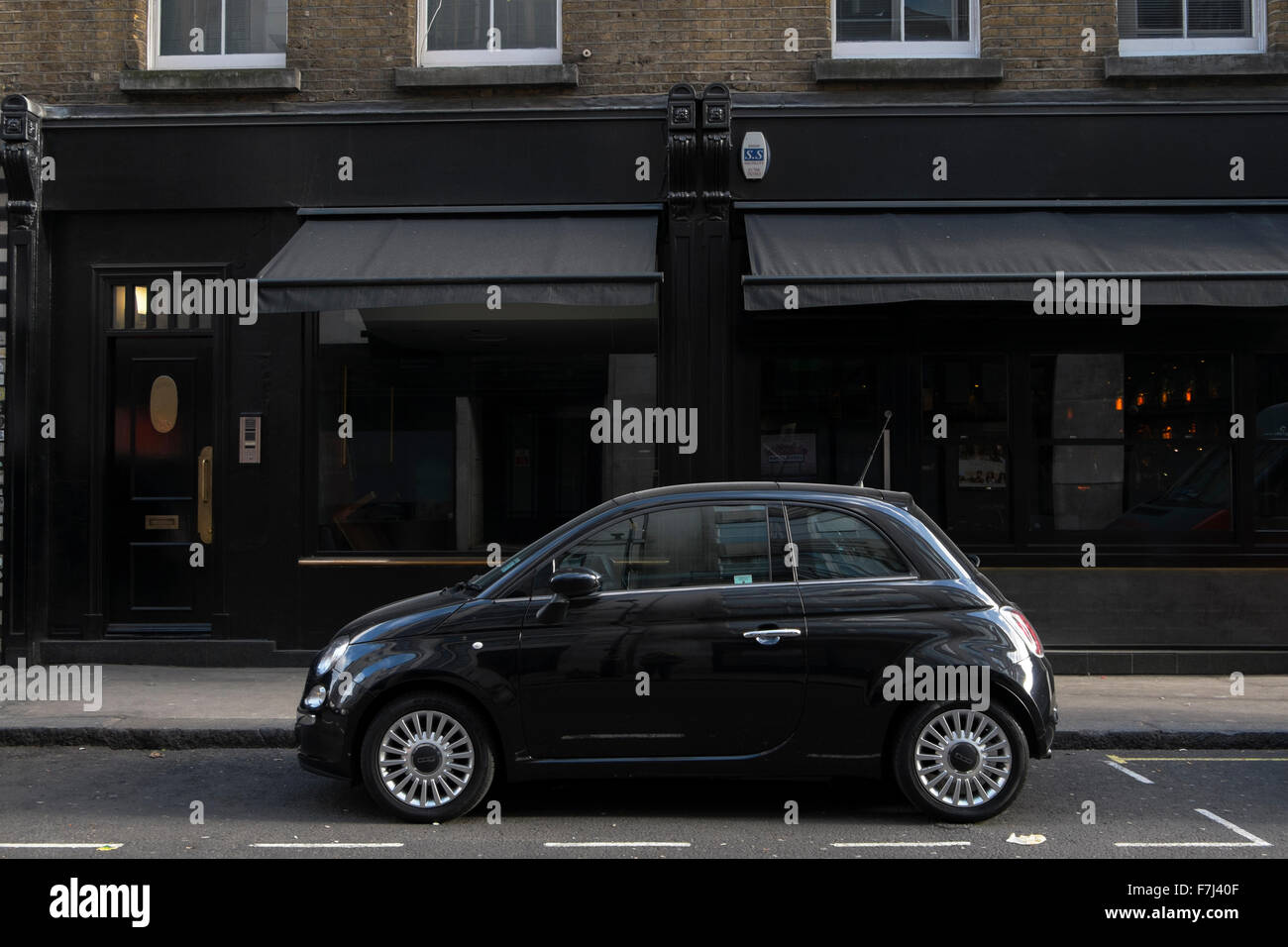 Black Fiat Cinquecento 500 car parked in Wardour Street, Soho, London, England, UK Stock Photo