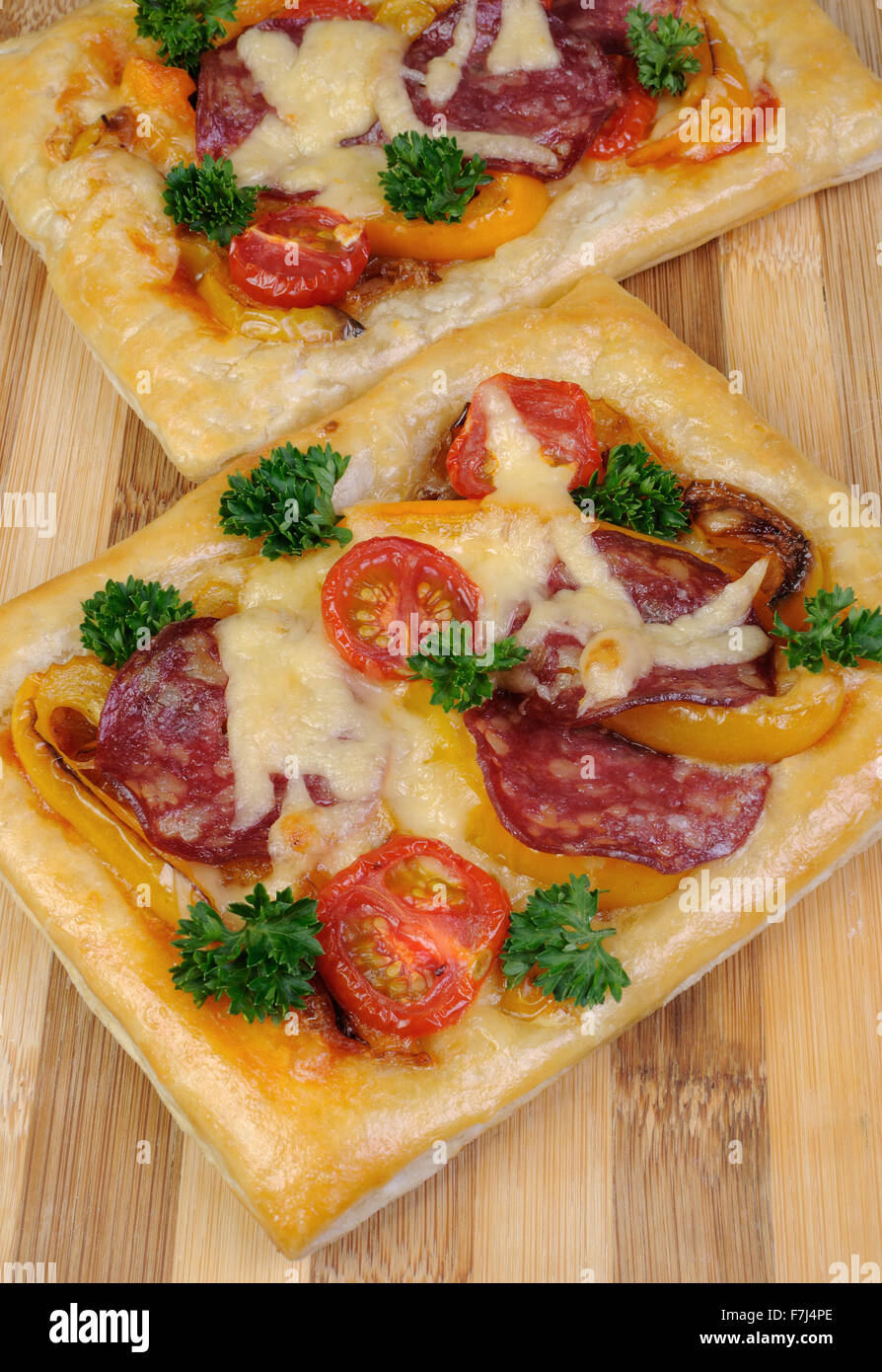 Mini pizza with vegetables, salami and cheese Stock Photo