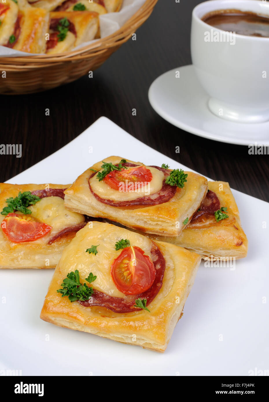Appetizer of puff pastry with salami, cheese and cherry tomatoes Stock Photo