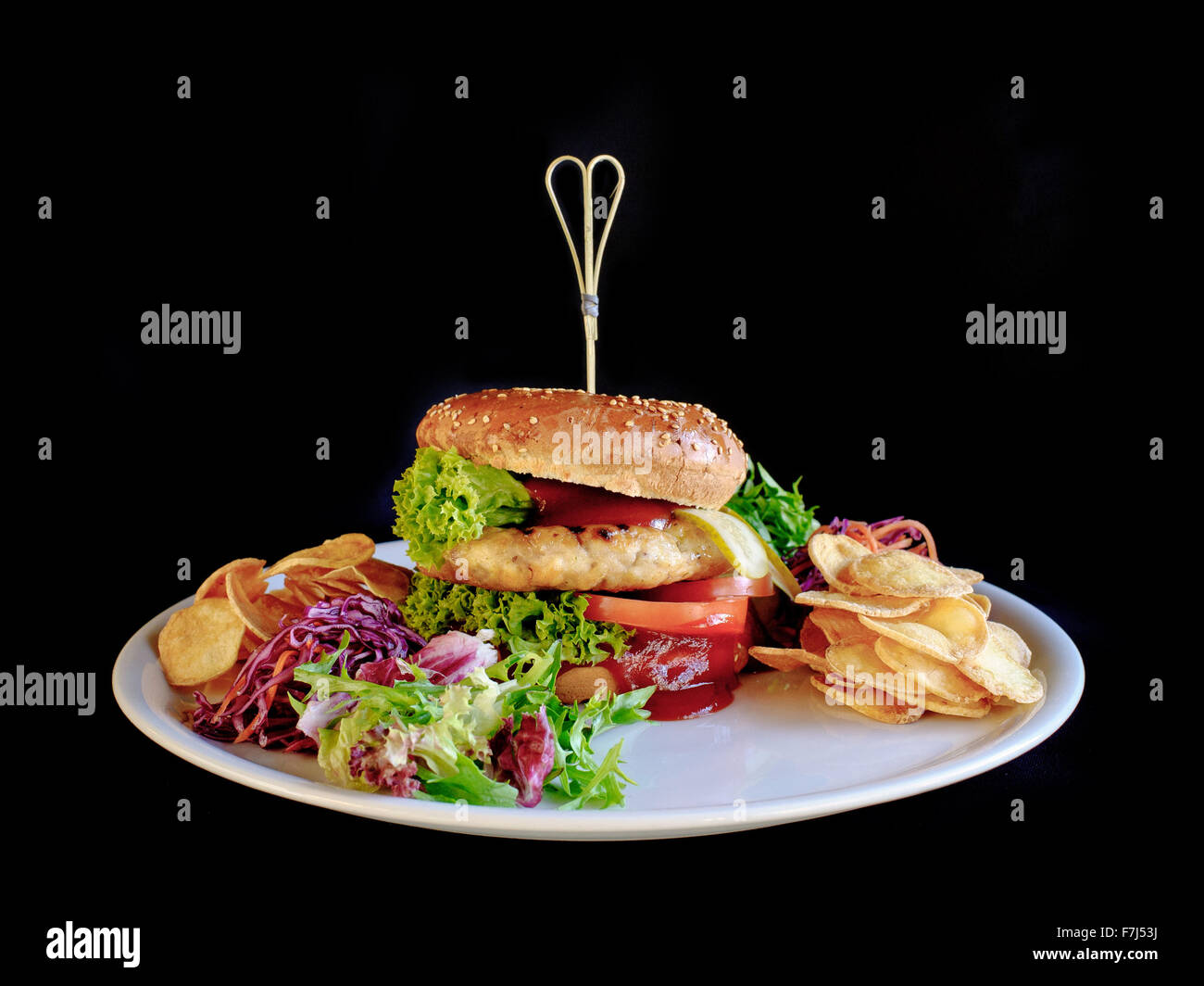 chicken burger with fried potatoes and vegetables Stock Photo
