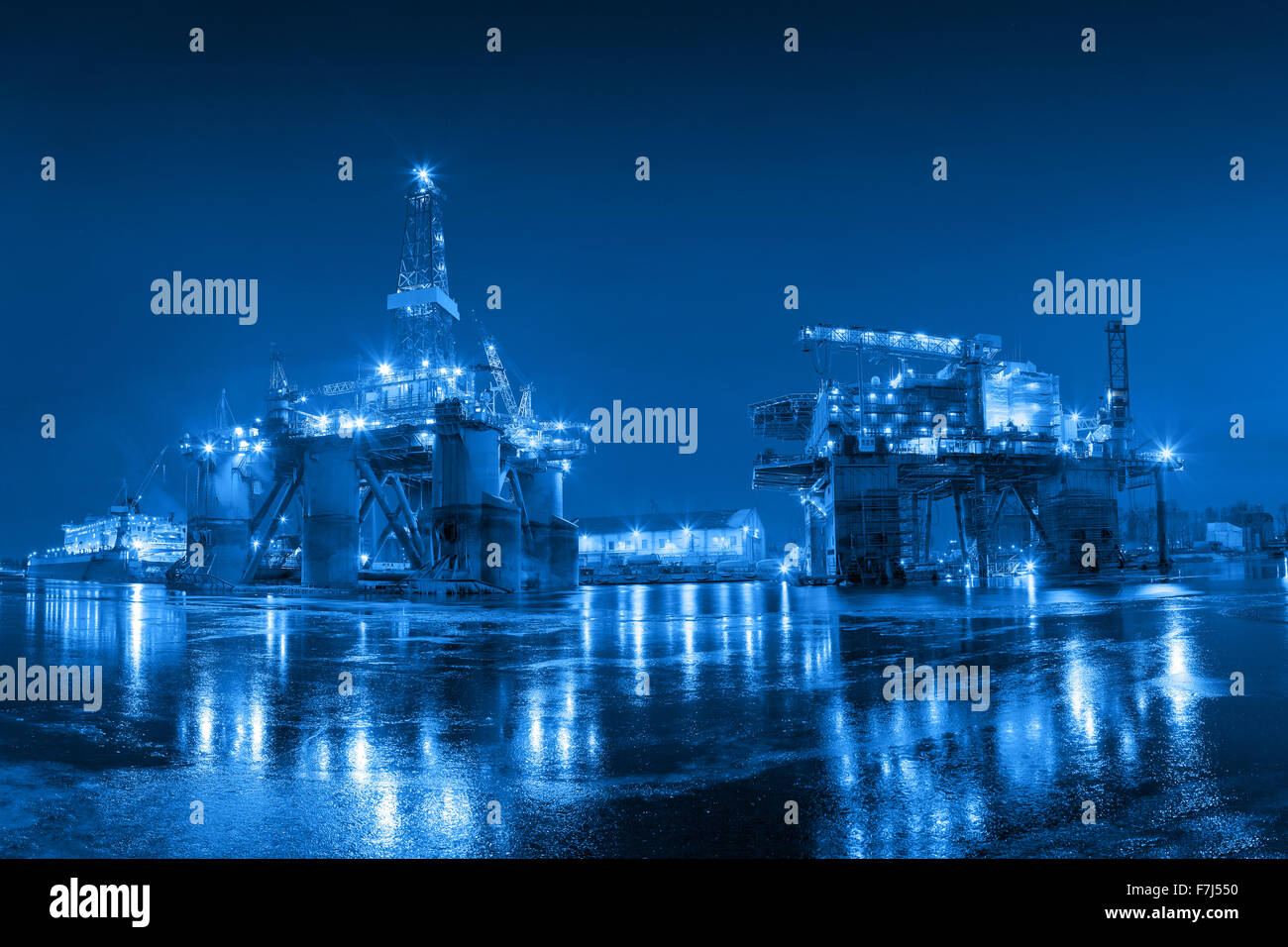 Oil Rig at night in Shipyard - industry concept. Stock Photo
