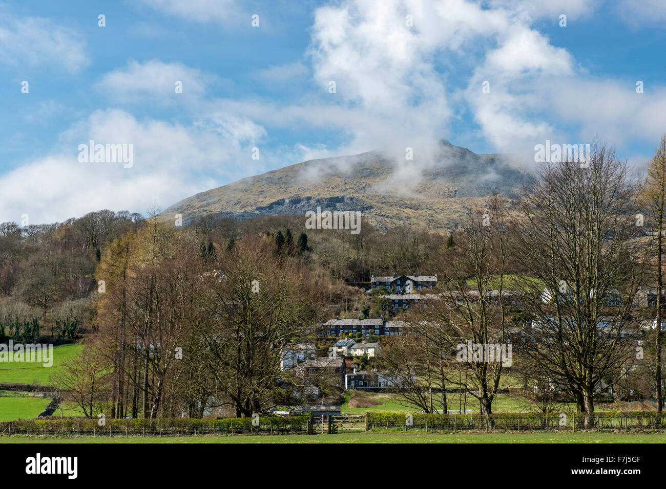 Coniston Old Man behind Coniston village Lake District National Park in Cumbria on a sunny day in April Stock Photo