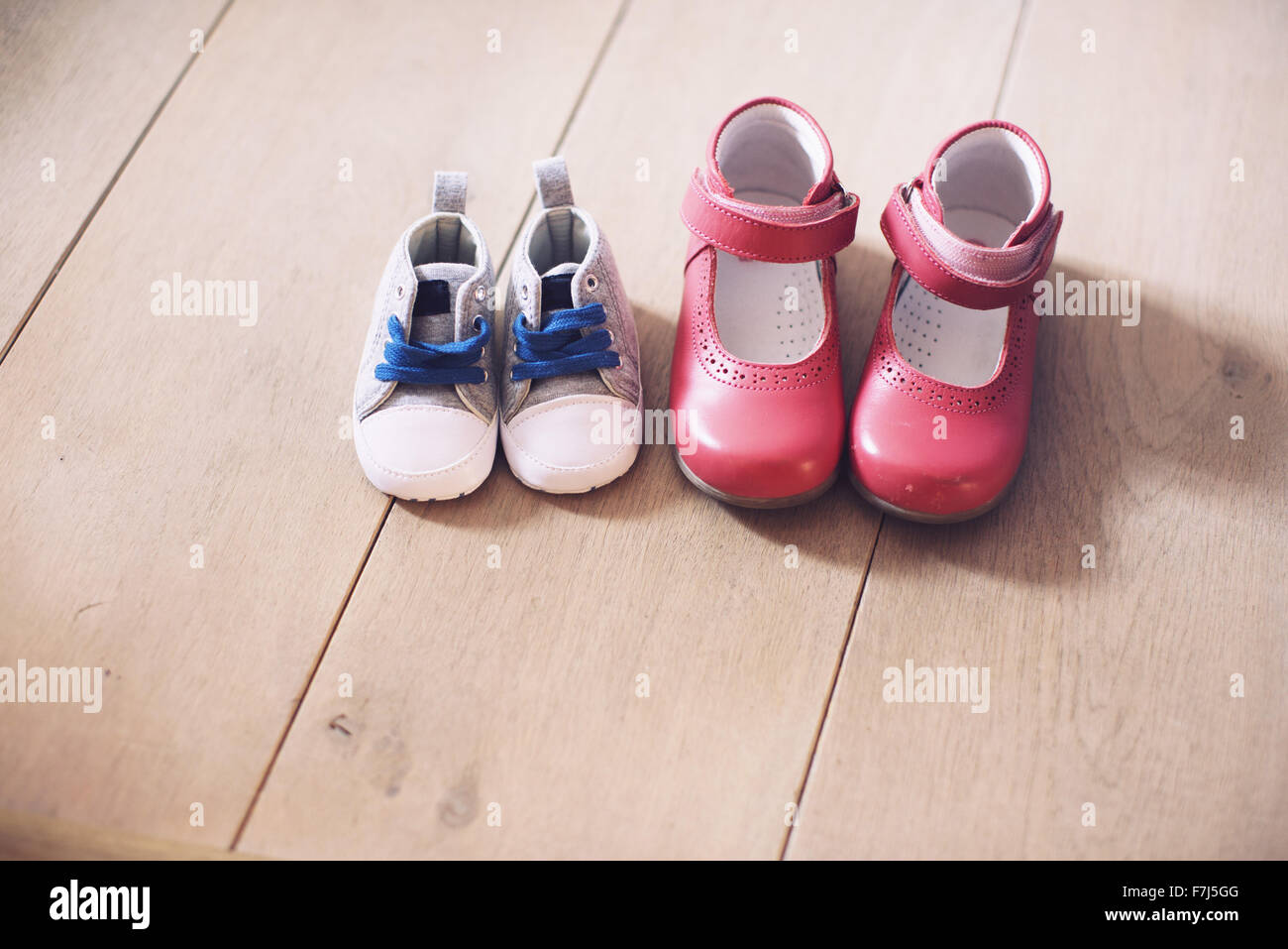 Children's shoes side by side on floor Stock Photo