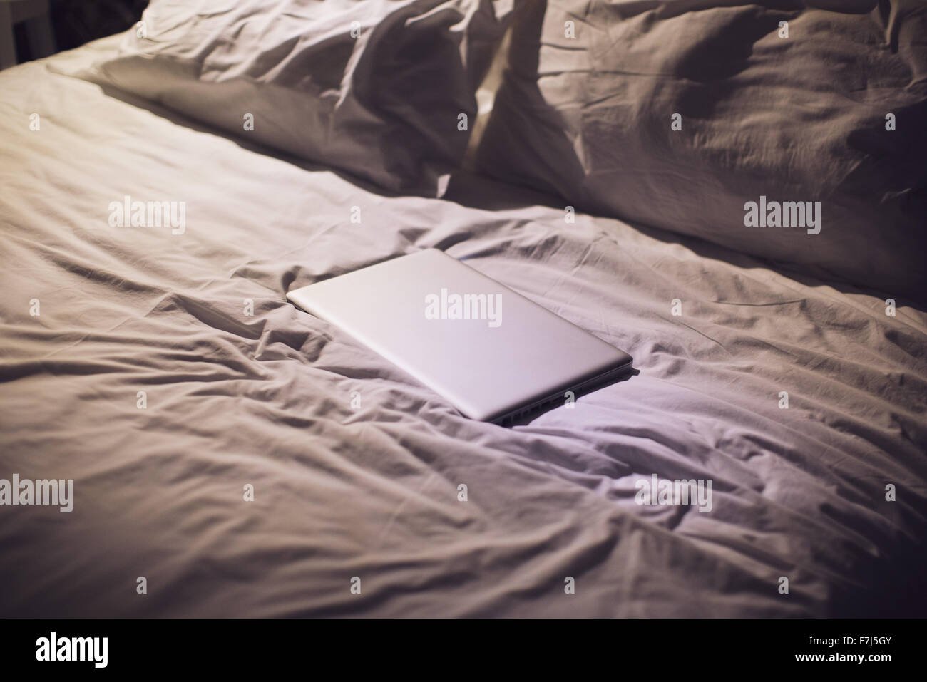 Laptop computer on bed Stock Photo Alamy