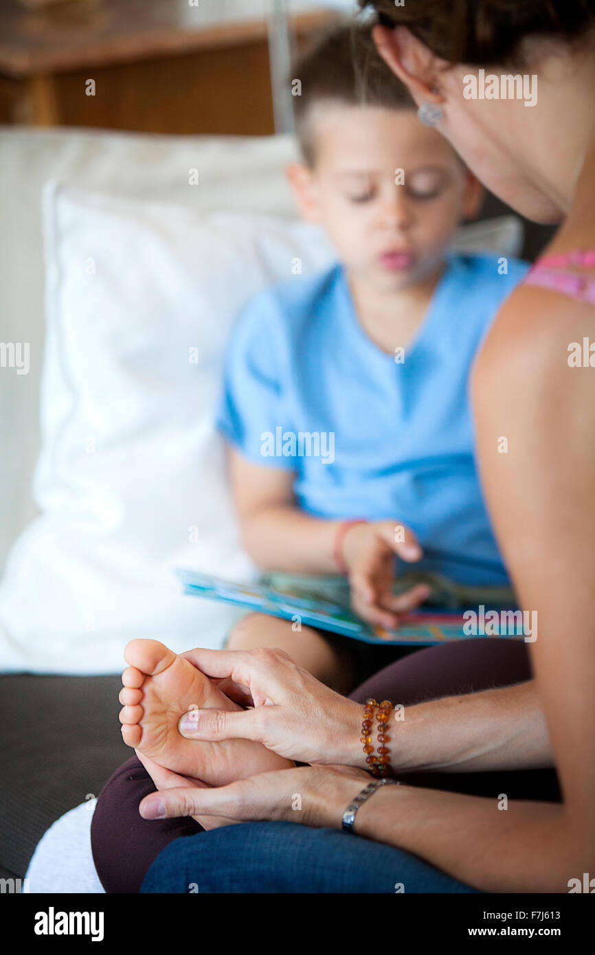 Reportage on foot reflexology for children. The reflexologist deals