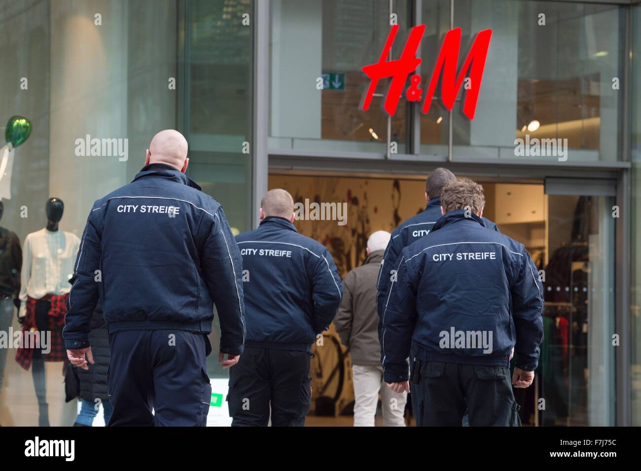 Security staff from the Dresdner City Streife (lit. Dresden city patrol)  going into a branch of Swedish clothing store H&M in Dresden, Germany, 1  December 20115. The two-month pilot project was commissioned