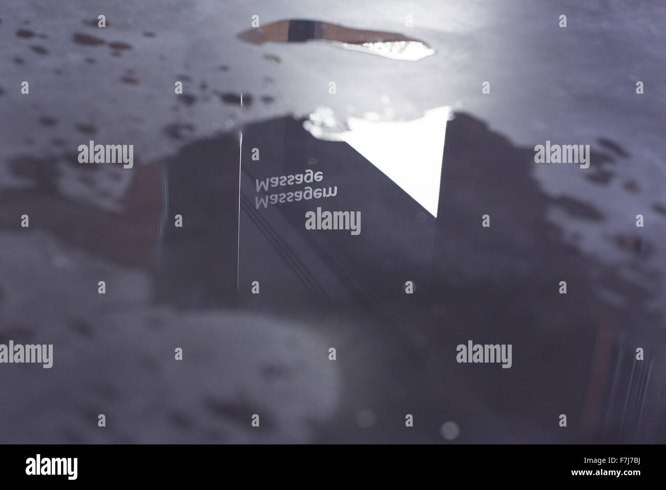 Puddle with reflection of sign reading "massage Stock Photo Alamy