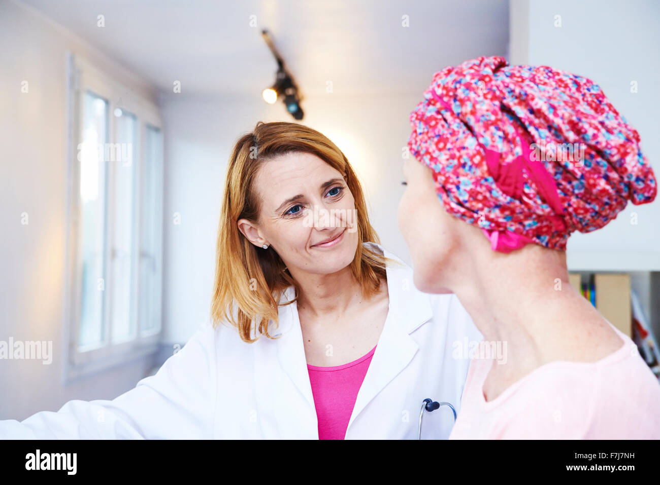 Discussing Cancer Doctor discussing cancer with elderly hi-res stock photography and ...