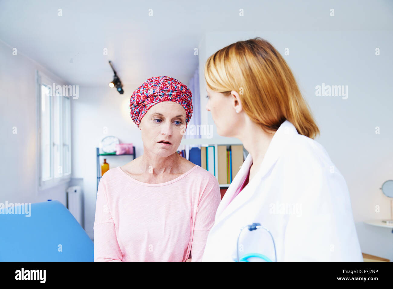 Discussing Cancer Doctor discussing cancer with elderly hi-res stock photography and ...