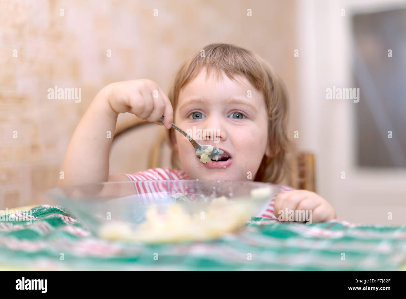 child eats with spoon in home Stock Photo - Alamy