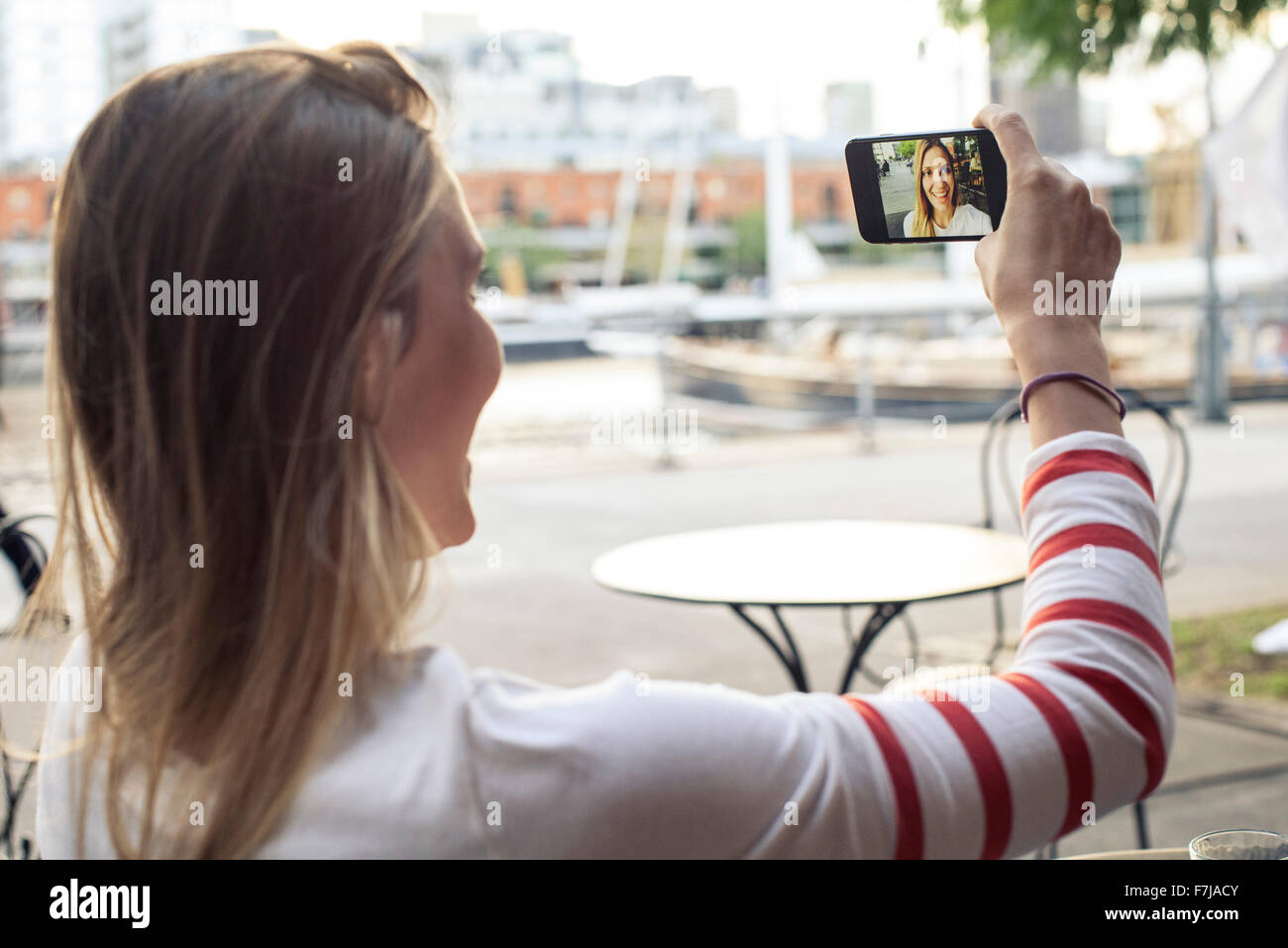 Young woman posing for a selfie at outdoor cafe Stock Photo