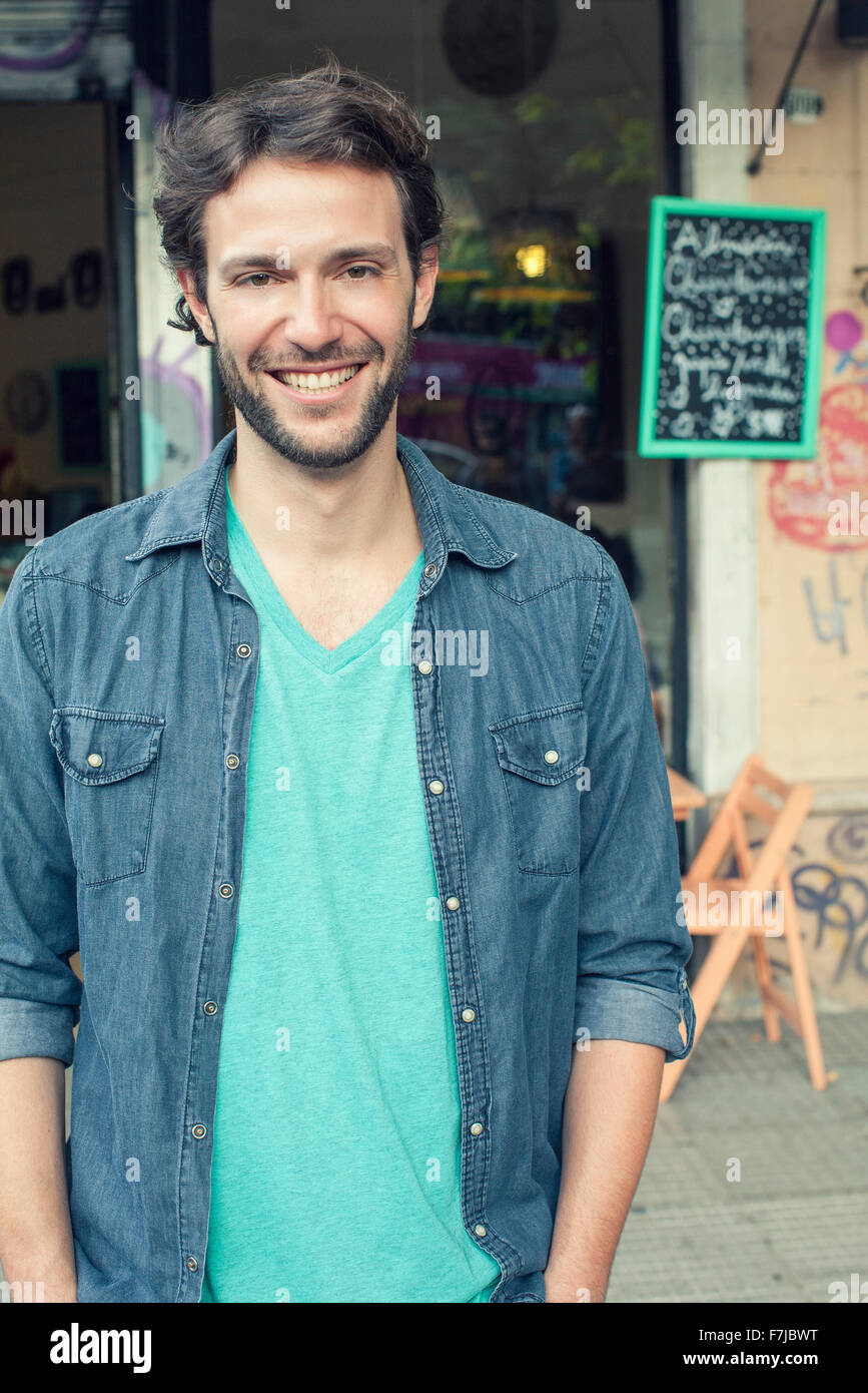 Man standing outside of cafe, portrait Stock Photo