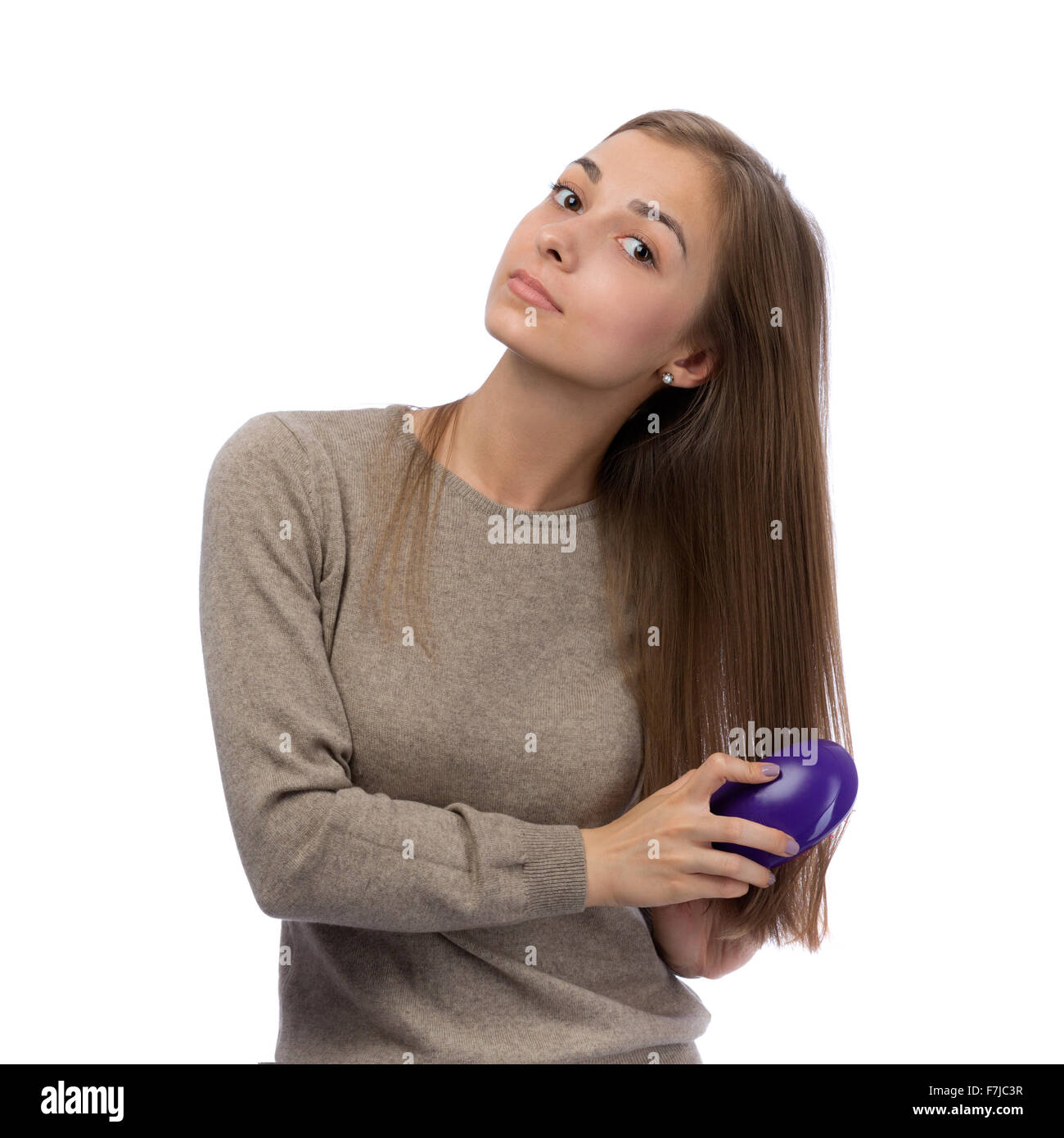 20 year old girl is combed in studio. Isolate on white. Stock Photo
