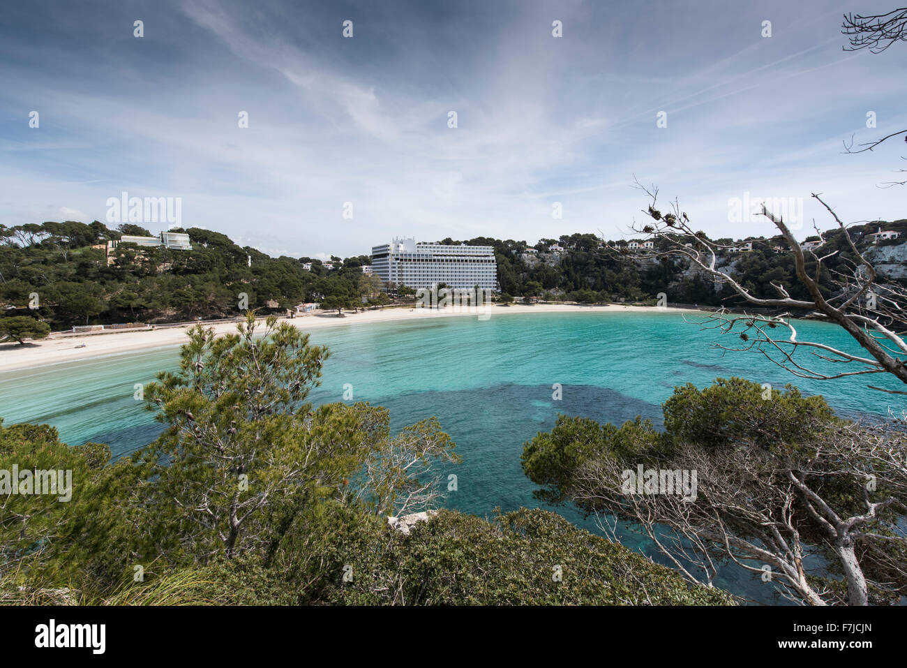 The beautiful curved bay and sandy beach at Cala Galdana on the south coat of the Balearic Island of Menorca. Stock Photo