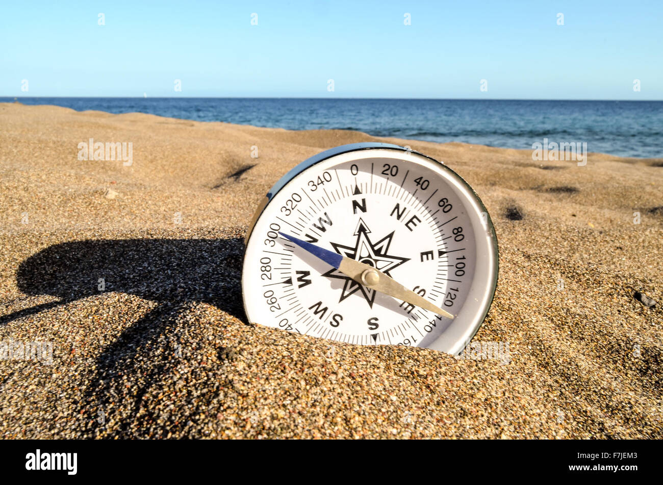 Compass on the Sand Beach Stock Photo - Alamy