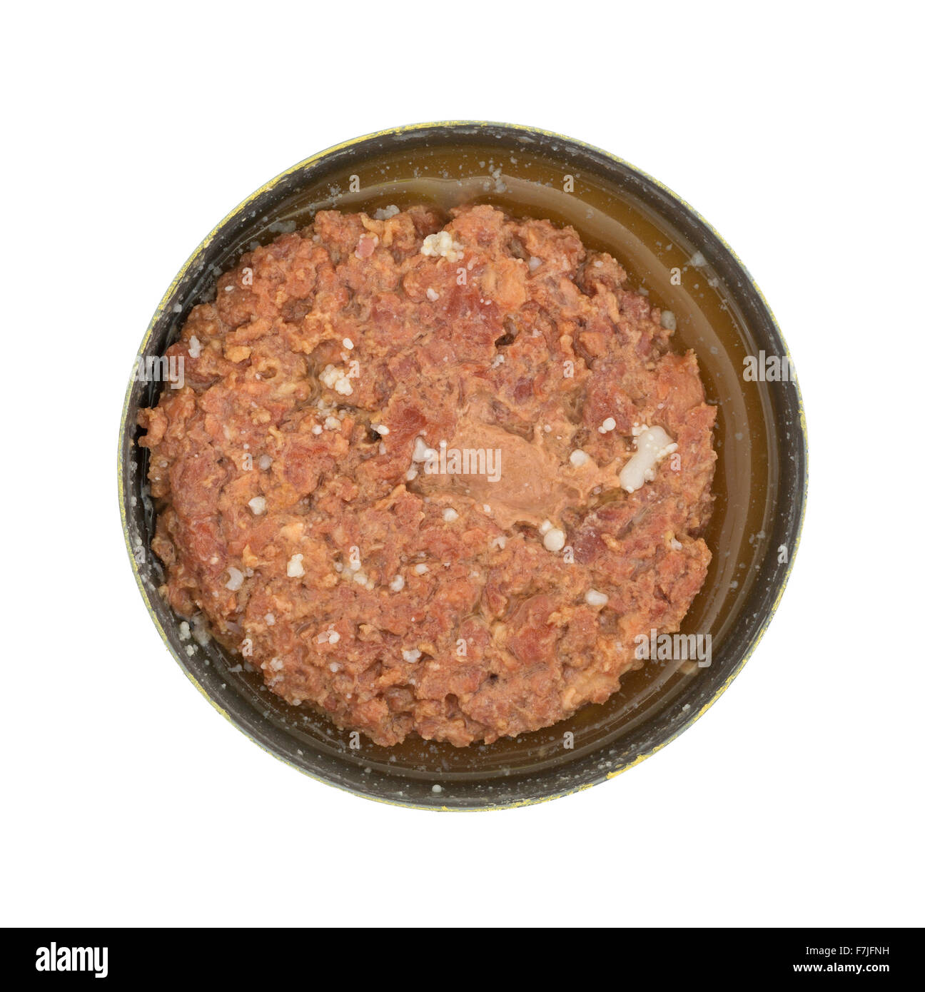 Top view of a large chunk of canned corned beef in the tin can with brine isolated on a white background. Stock Photo