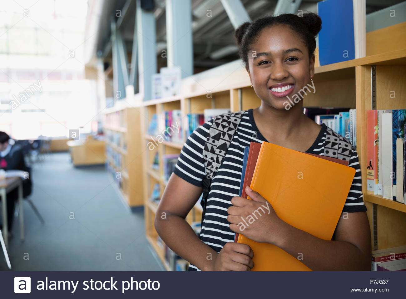 Portrait confident high school student in library Stock Photo