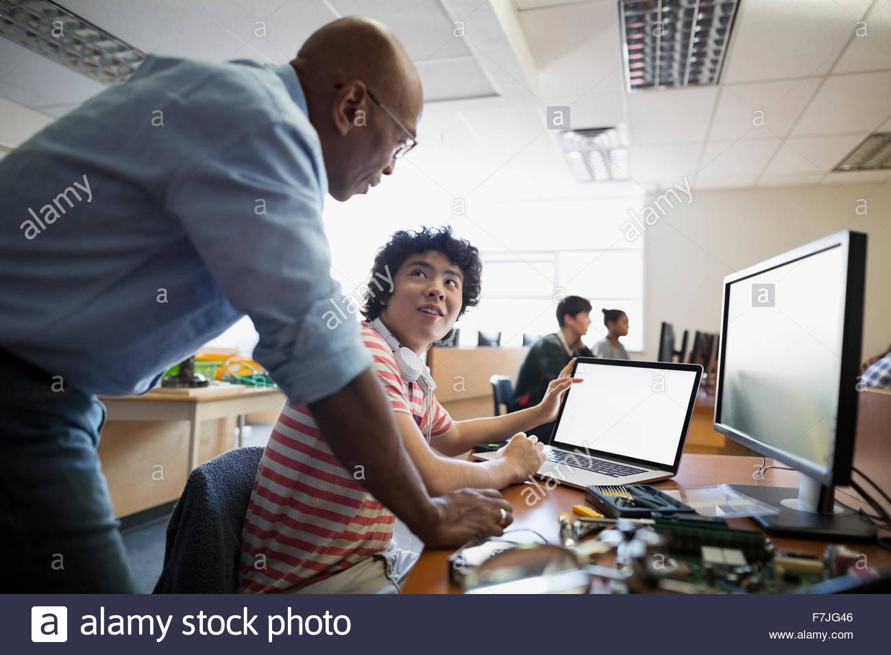 High school teacher student using laptop computer class Stock Photo