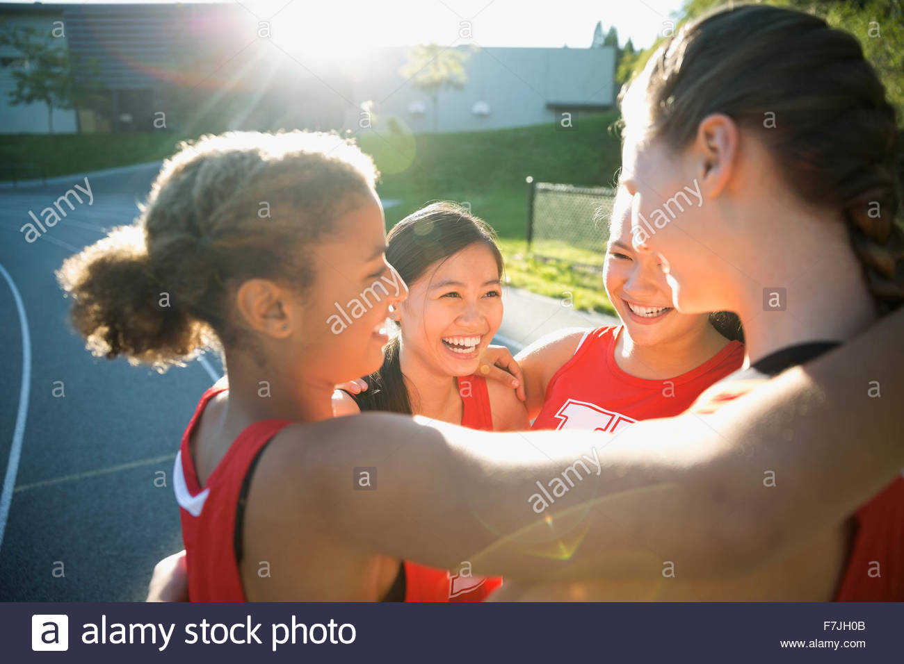 Female high school track and field athletes huddling Stock Photo Alamy