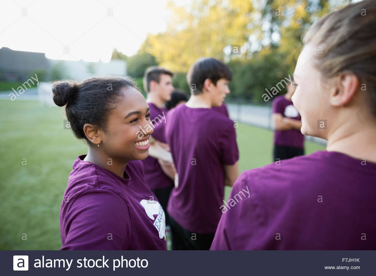 Smiling high school students talking in physical education Stock Photo