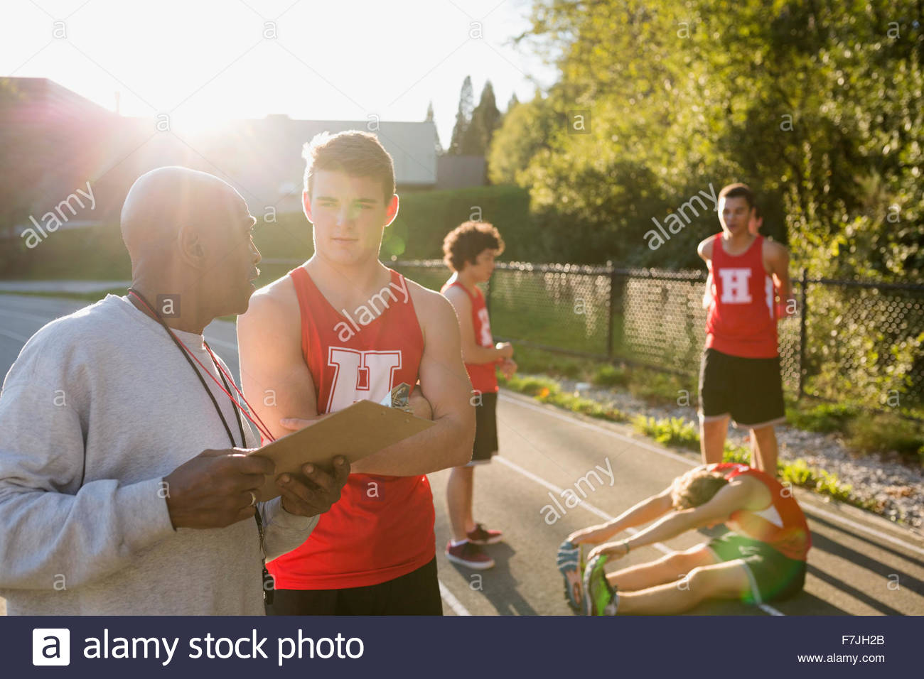 Coach and high school track and field athlete Stock Photo Alamy