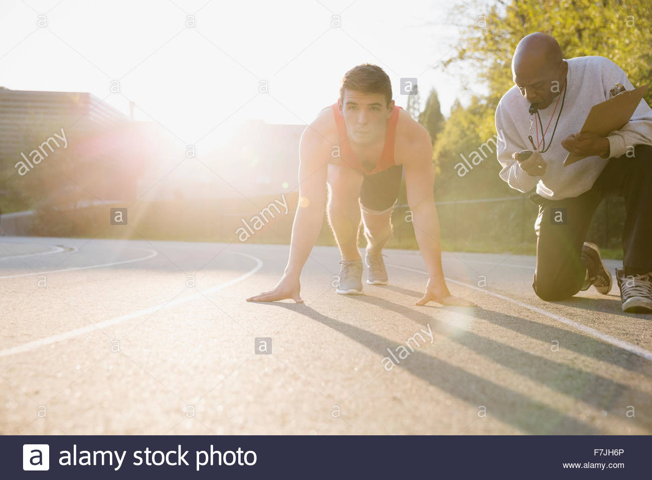 Coach timing high school track and field athlete Stock Photo Alamy