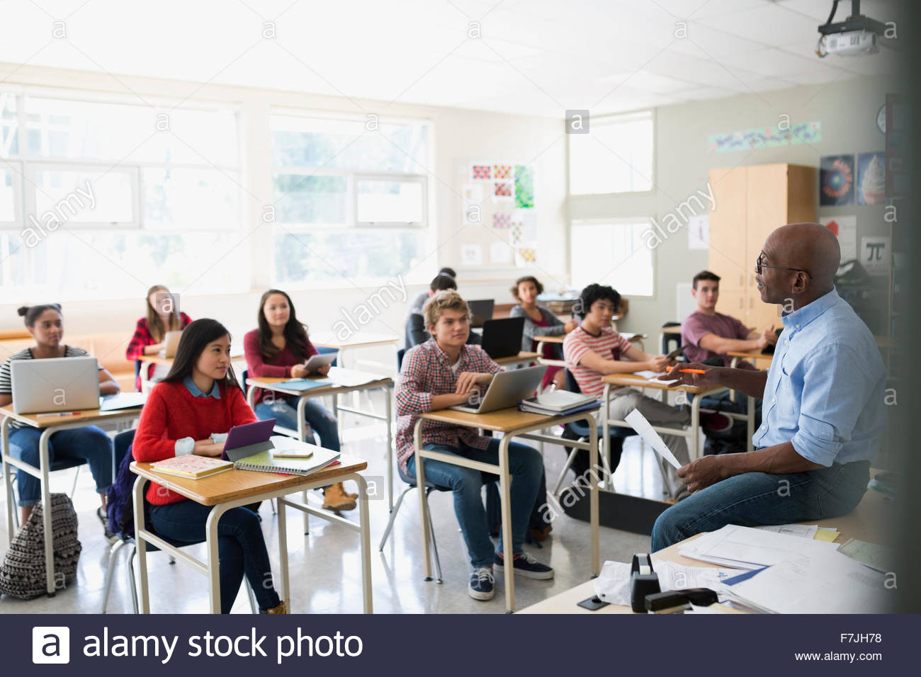 High school students listening to teacher in classroom Stock Photo