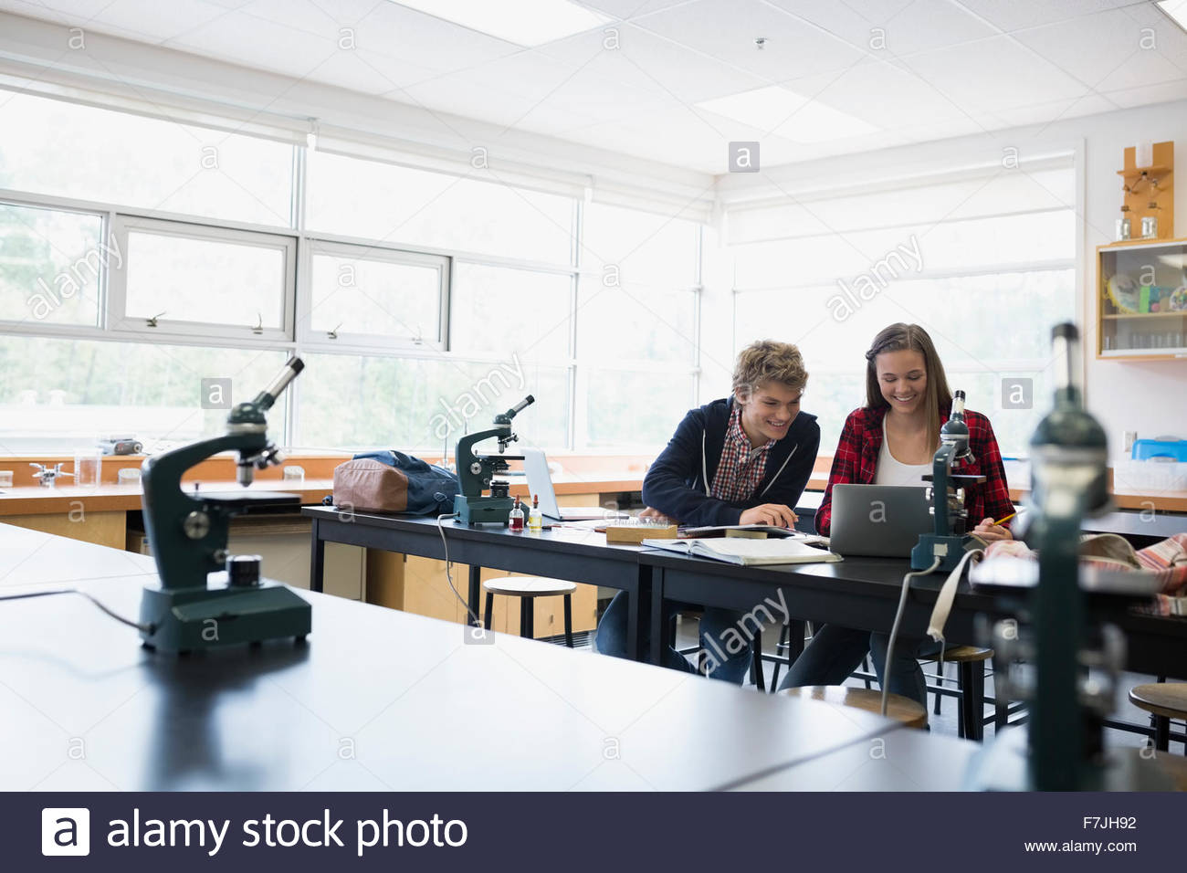 Sitting reading technology microscope learning education hires stock