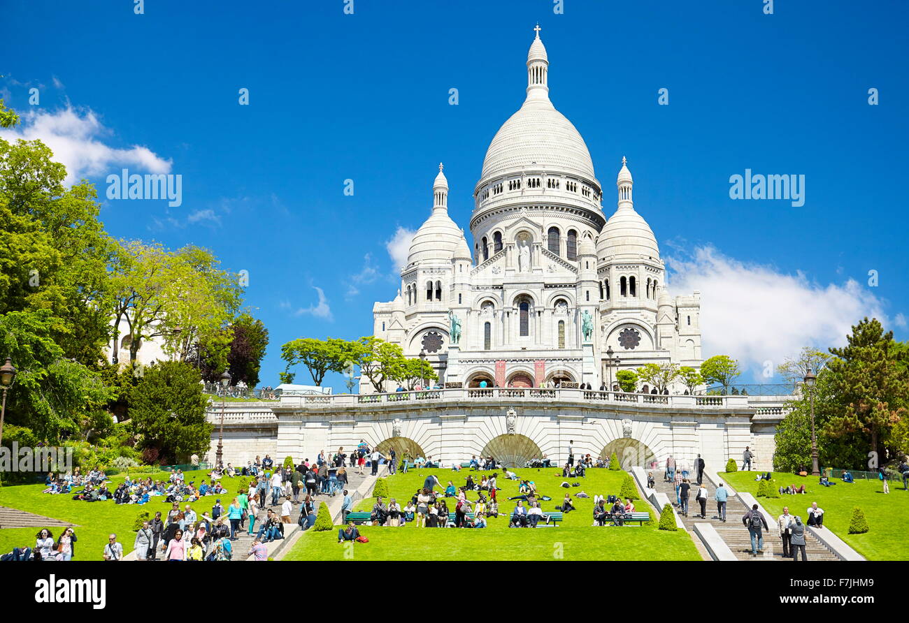 Tourists on the steps in front of the Basilica of The Sacred Heart (Du Sacre-Coeur), Montmartre District, Paris, France Stock Photo