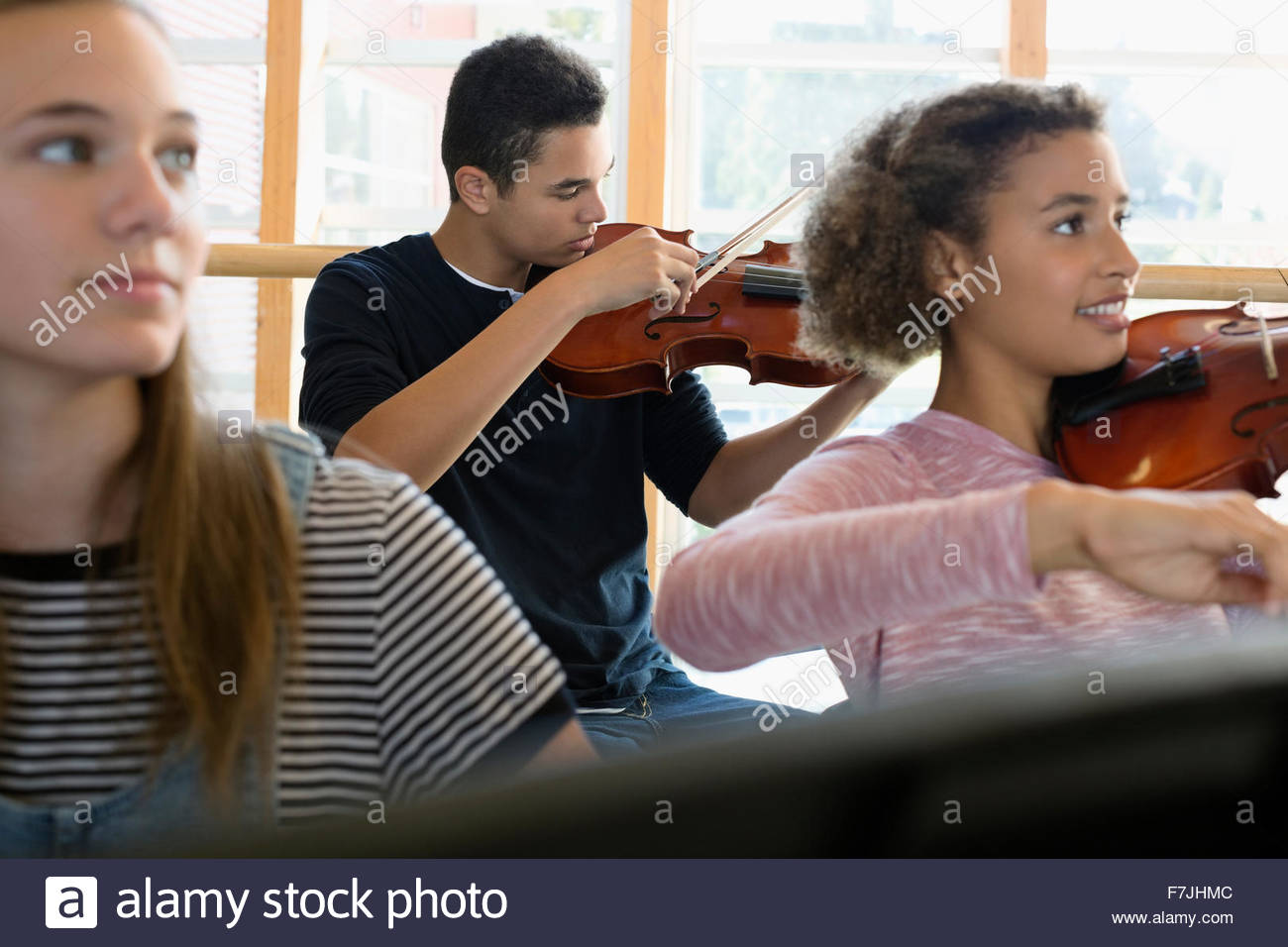 High school students playing violin in music class Stock Photo