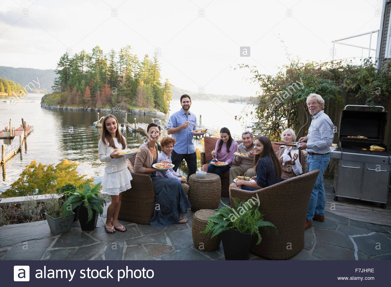 Portrait multigeneration family enjoying barbecue lakeside patio Stock Photo Alamy