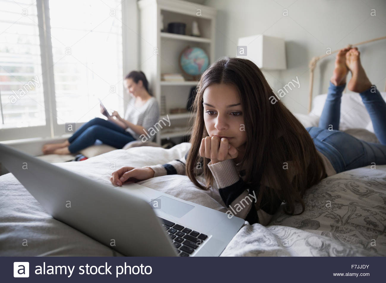 Homework laptop on her bed hires stock photography and images Alamy