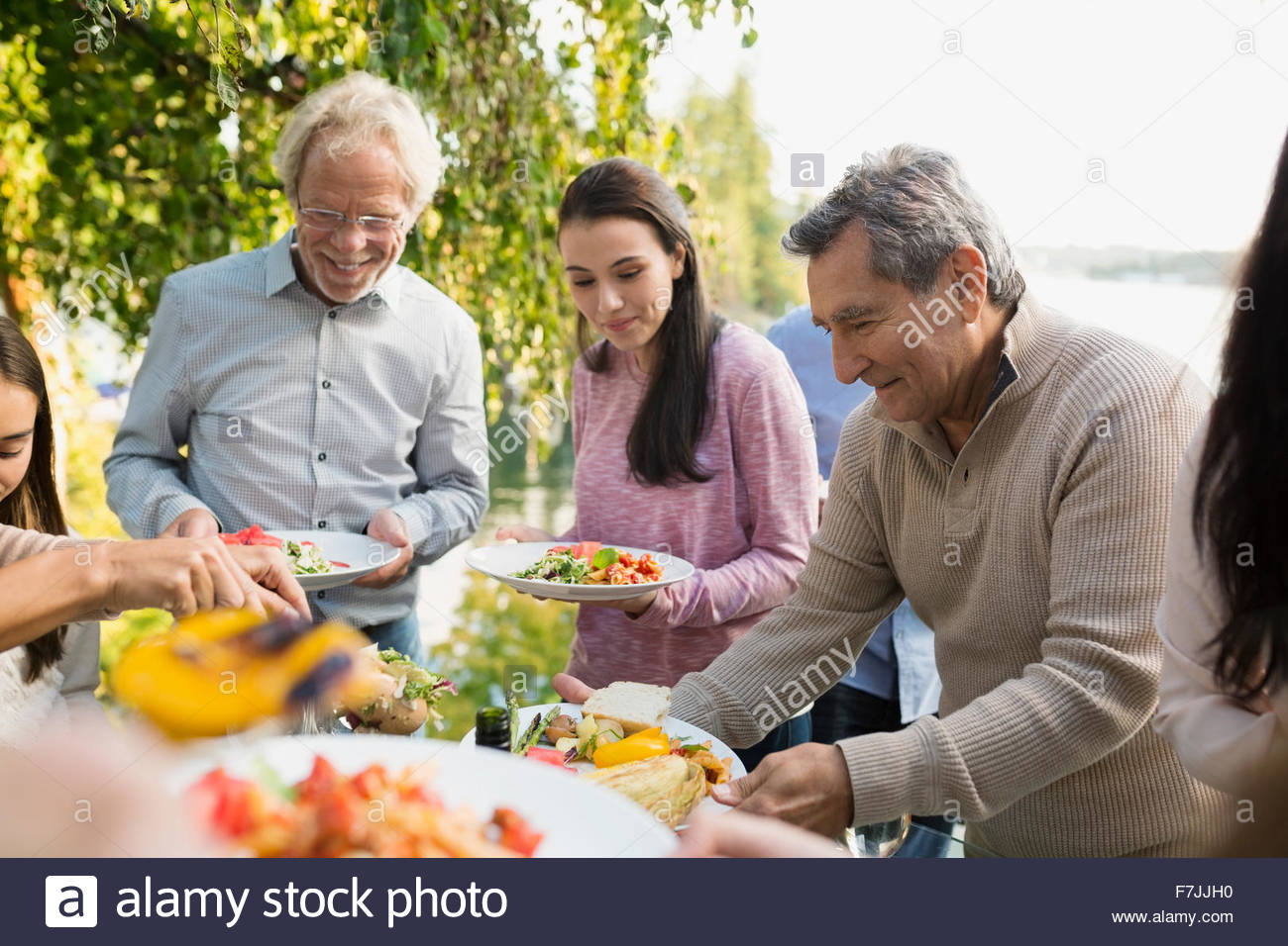Multi-generation family serving food at buffet patio Stock Photo