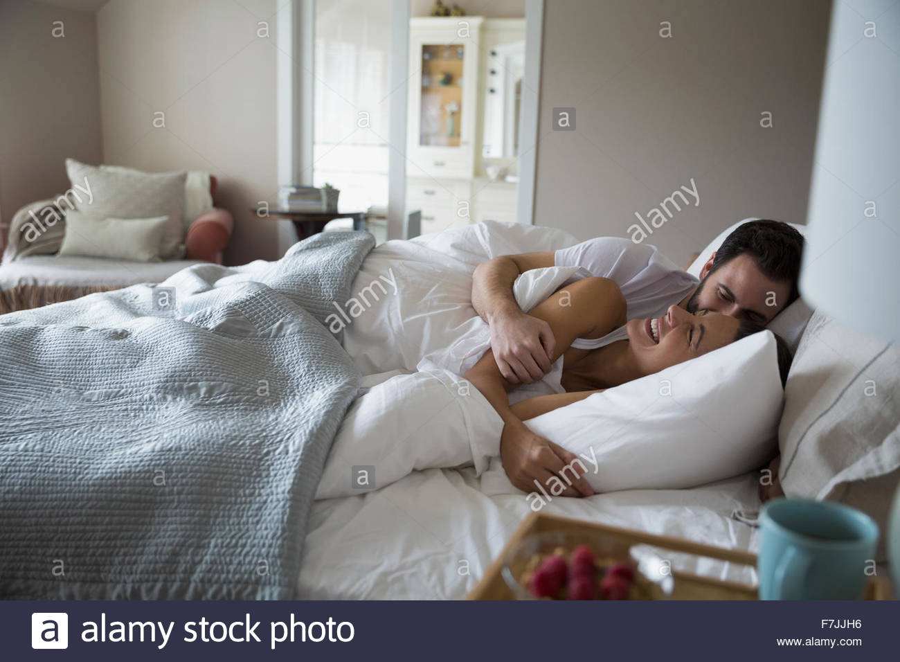 Couple in bed laughing hi-res stock photography and images - Alamy
