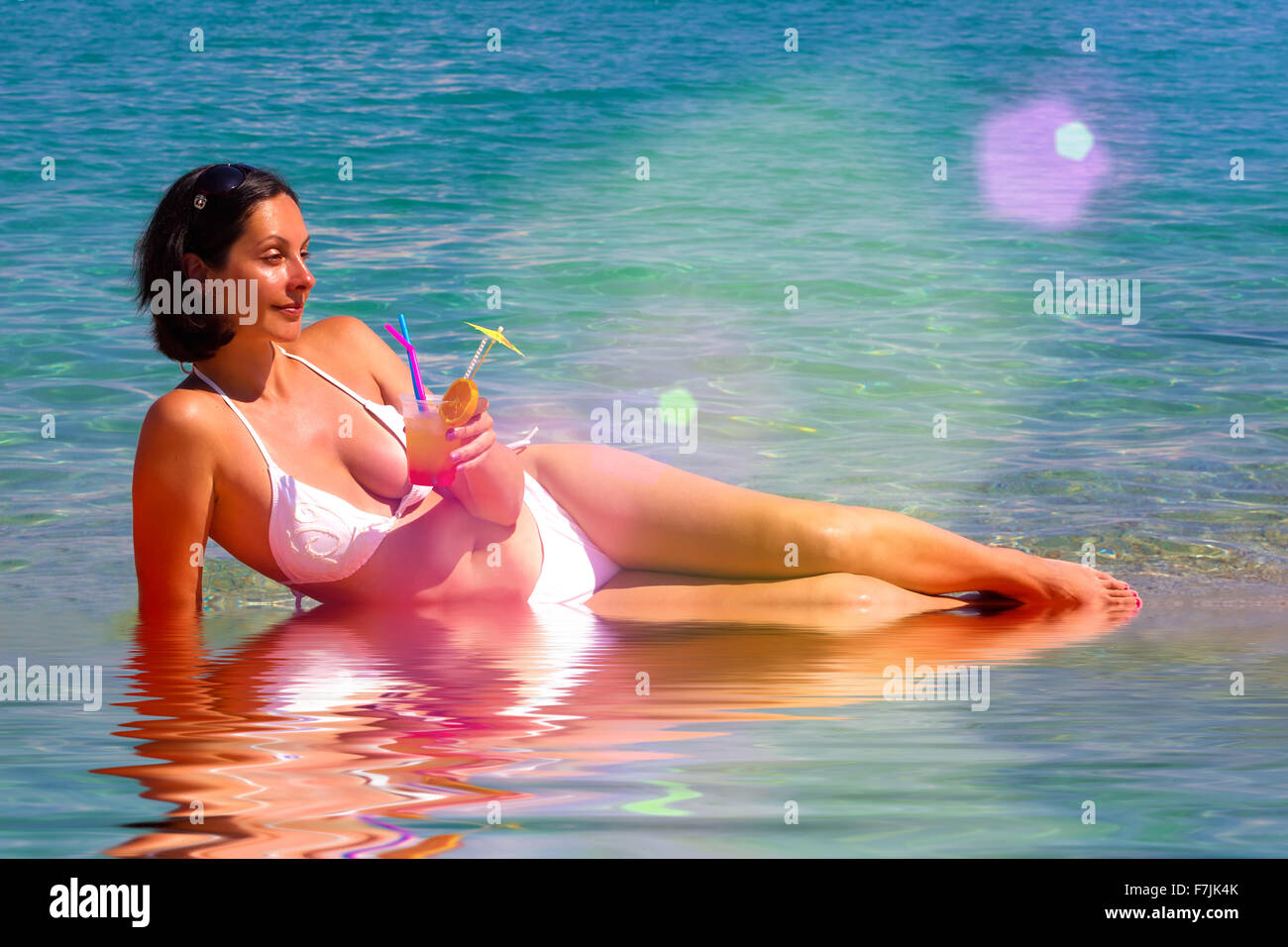 Enjoying in a cocktail and sea Stock Photo