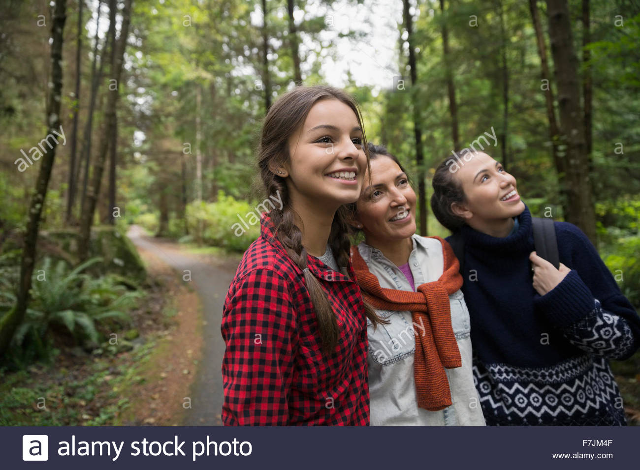 Mother and daughters hiking in woods Stock Photo