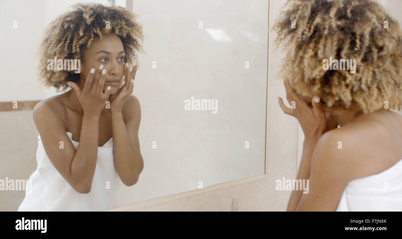 Woman Viewing Herself In The Mirror Stock Photo