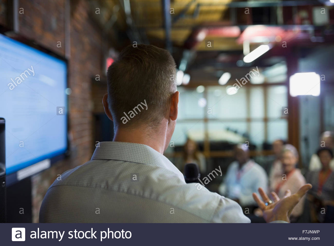 Businessman speaking to conference audience Stock Photo
