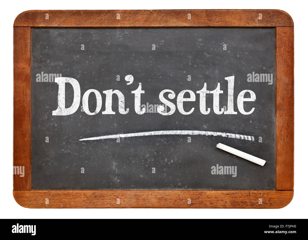 Do not settle - motivational advice in white chalk on a vintage slate blackboard Stock Photo