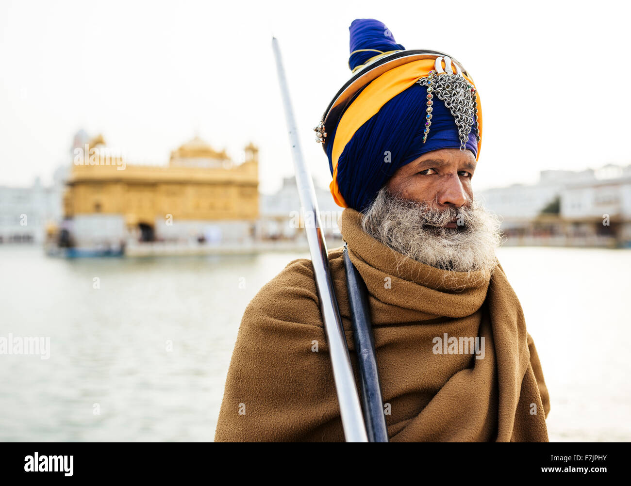 Portrait of a Sikh guard holding a spear, Golden Temple, Amritsar, Punjab, India Stock Photo