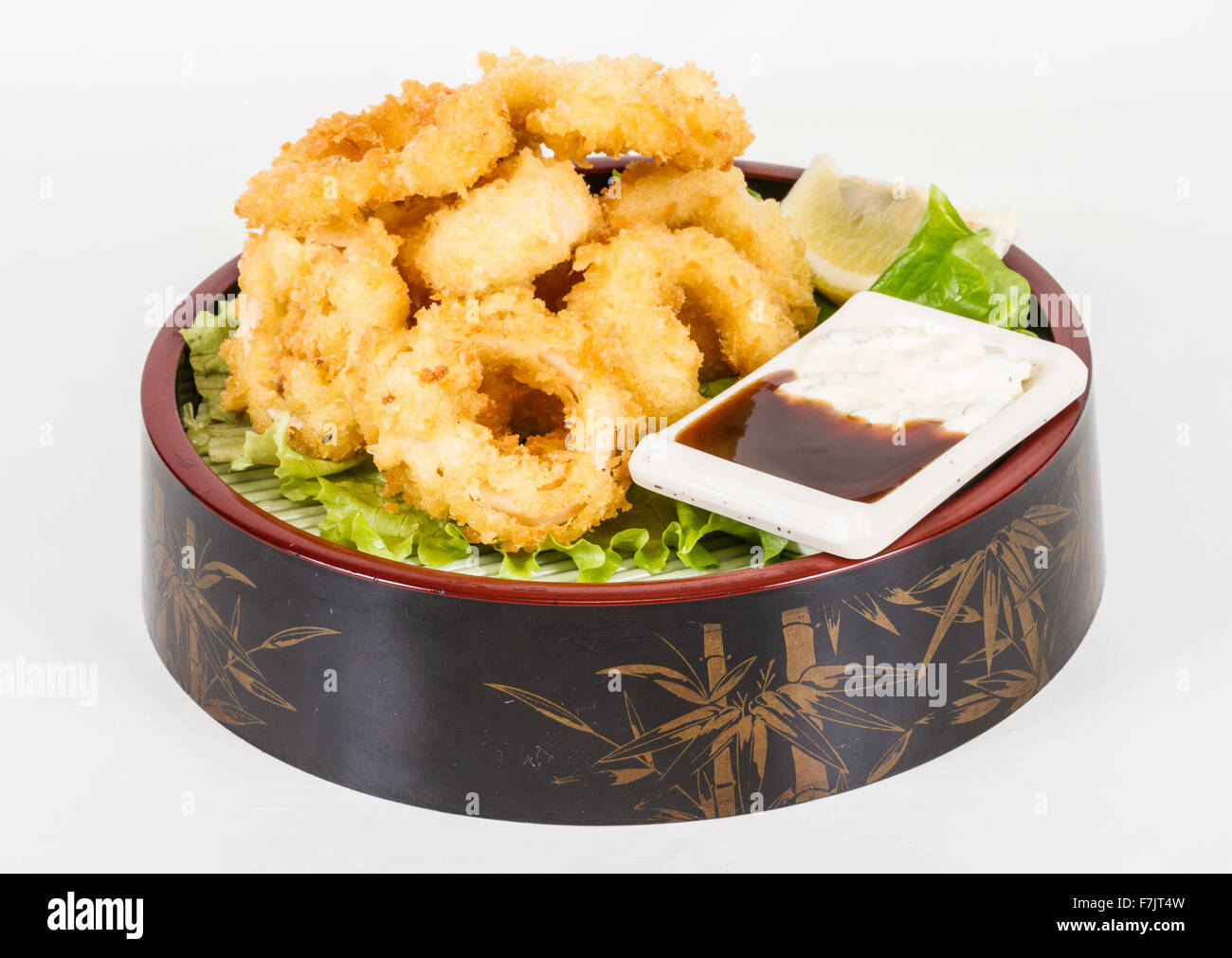 Deep batter fried squid rings calamari with green salad Stock Photo - Alamy